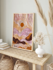Aboriginal dot painting of an abstract desert landscape with a central sun, in earthy browns, in an alternate framed mockup