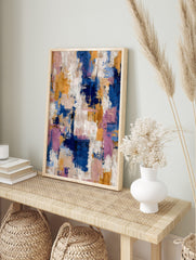 Abstract art print with blue, gold, pink, and white textured brushstrokes in a dynamic, in an alternate framed mockup