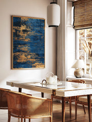 Abstract blue and gold textured wall art print with horizontal streaky patterns, in a styled room mockup