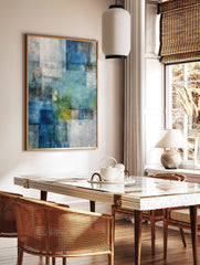Abstract art print with layered blue, green, and white rectangular blocks and textured brushstrokes, in a styled room mockup