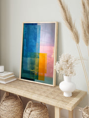 Abstract colour block art print with overlapping rectangles in blue, orange, and pink hues, in an alternate framed mockup