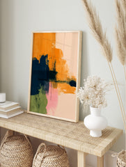 Abstract art print with bold orange, navy blue, pink, and green brushstrokes on a light, in an alternate framed mockup
