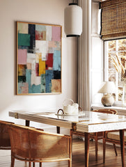 Abstract art print with textured rectangular blocks in red, blue, green, pink, yellow, and white, in a styled room mockup