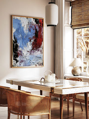 Abstract expressionist art print with bold blue, red, black, and white textured brushstrokes, in a styled room mockup