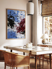 Abstract expressionist art print with blue, white, black, and red energetic brushstrokes and fine, in a styled room mockup