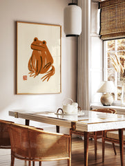 Abstract orange frog art print with painterly brushstrokes on a neutral background, in a styled room mockup