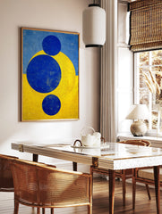 Abstract geometric art print with three blue circles and a yellow arc against a split blue and, in a styled room mockup