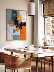 Abstract geometric wall art with orange, grey, black, and white blocks, distressed textures, and an, in a styled room mockup