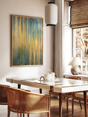 Abstract art print with shimmering vertical gold, teal, and blue stripes, featuring a textured, in a styled room mockup