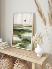 Abstract green seascape wall art with layered washes, white wavy lines, and a golden sun on, in an alternate framed mockup