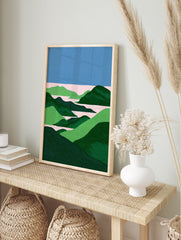 Abstract landscape wall art print with blue sky, pink water, and green rolling hills in a stippled, minimalist style. - Image 3