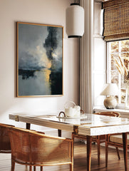 Abstract art print with dark grey, blue, and gold colours depicting a misty landscape with, in a styled room mockup