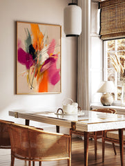 Abstract painting with energetic orange, fuchsia, black, and white brushstrokes and lines on a, in a styled room mockup