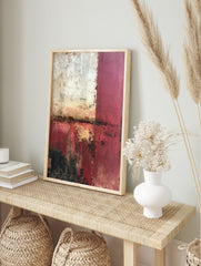 Abstract wall art with distressed red, white, and black textures, and gold highlights in a, in an alternate framed mockup