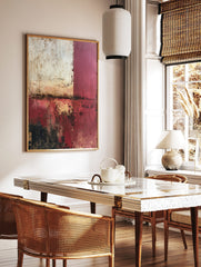 Abstract wall art with distressed red, white, and black textures, and gold highlights in a portrait, in a styled room mockup