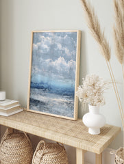 Textured abstract seascape art print with stormy blue and grey clouds over choppy ocean water, in an alternate framed mockup