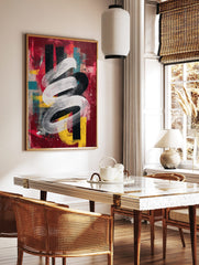 Abstract art print with a swirling white brushstroke over distressed red, black, yellow, and teal, in a styled room mockup