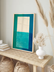 Abstract geometric art print with white and teal central block, framed by teal, turquoise, in an alternate framed mockup