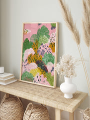 Abstract landscape art print with textured organic shapes in pink, green, and mustard yellow, in an alternate framed mockup