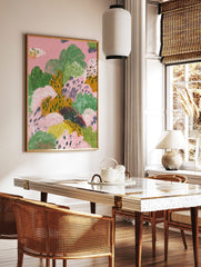 Abstract landscape art print with textured organic shapes in pink, green, and mustard yellow, in a styled room mockup