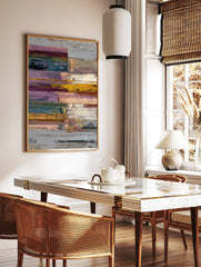 Textured abstract wall art print with horizontal blocks in purple, yellow, blue, green, and white, in a styled room mockup