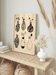 Minimalist black and white line art of six vases with flowers on a beige background, in an alternate framed mockup