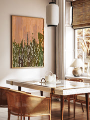 Abstract wall art with vertical orange and green lines, suggesting a modern cityscape or landscape with white dappled light. - Image 2