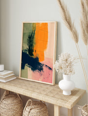Abstract art print with bold orange, navy, and green brushstrokes on a pale pink background, in an alternate framed mockup
