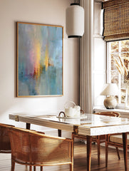 Abstract wall art with vertical gradients of soft blue, yellow, pink, and red with visible textured, in a styled room mockup