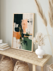 Abstract art print with teal, orange, green, and peach colour blocks, accented by black lines, in an alternate framed mockup