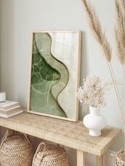 Overhead view of abstract wavy organic lines in green and beige water with light reflections, in an alternate framed mockup