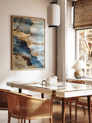 Abstract weathered wall art with layers of blue, grey, and textured gold, depicting peeling surfaces, in a styled room mockup
