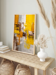 Abstract art print with textured yellow, grey, brown, and white blocks and visible, in an alternate framed mockup