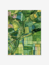 Aerial view of green terraced rice fields forming a natural mosaic pattern on a hillside landscape