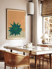 Illustrative agave plant print with spiky green leaves on a textured orange background and beige, in a styled room mockup
