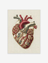 Anatomical heart embroidery style print with red vessels and cream tissue on neutral background