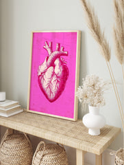 Detailed anatomical heart illustration print in bright pink and off-white with distressed, in an alternate framed mockup