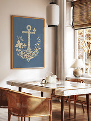 Illustrative beige anchor adorned with botanical flowers and leaves on a blue background, in a styled room mockup
