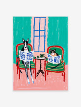 Whimsical animal wall art print depicting a black and white dog and cat reading newspapers in armchairs.