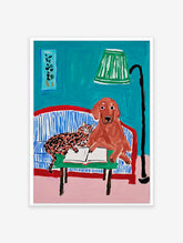 Illustrative animal wall art featuring a brown dog and a spotted cat reading a book on a blue striped couch with a green lamp.