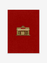 Art Deco cinema facade with gold columns and CINEMA sign on red background