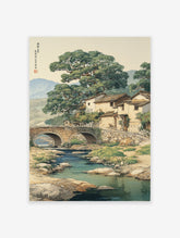 Traditional Asian landscape wall art depicting a Chinese village with a stone bridge over a river, large trees, and mountains.