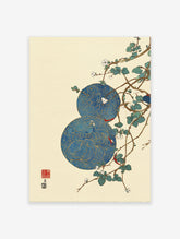 Asian wall art featuring two blue and gold patterned circles with white flowers and green leaves on brown branches, cream background.