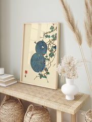 Asian wall art featuring two blue and gold patterned circles with white flowers and green leaves on brown branches, cream background. - Image 3