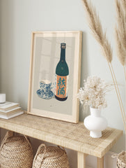Japanese autumn sake bottle and blue patterned teacup still life art print, in an alternate framed mockup