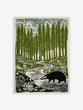 Illustrative print of a badger walking by a winding stream in a forest of tall green trees and white flowers