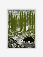 Illustrative print of a badger walking by a winding stream in a forest of tall green trees and white flowers