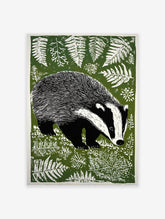 Green linocut style badger print amidst white ferns on a dark green background, woodland animal wall art.