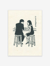 Illustrative print of a man and woman talking at a bar counter with glasses and Japanese text