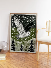 Barn owl flying across a starry night sky above a forest of pine trees, in a green and white linocut style print. - Image 2
